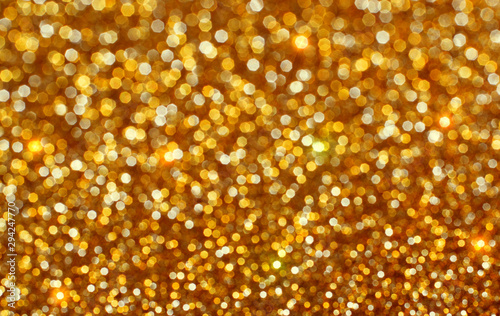 Shiny golden defocused glitter background.