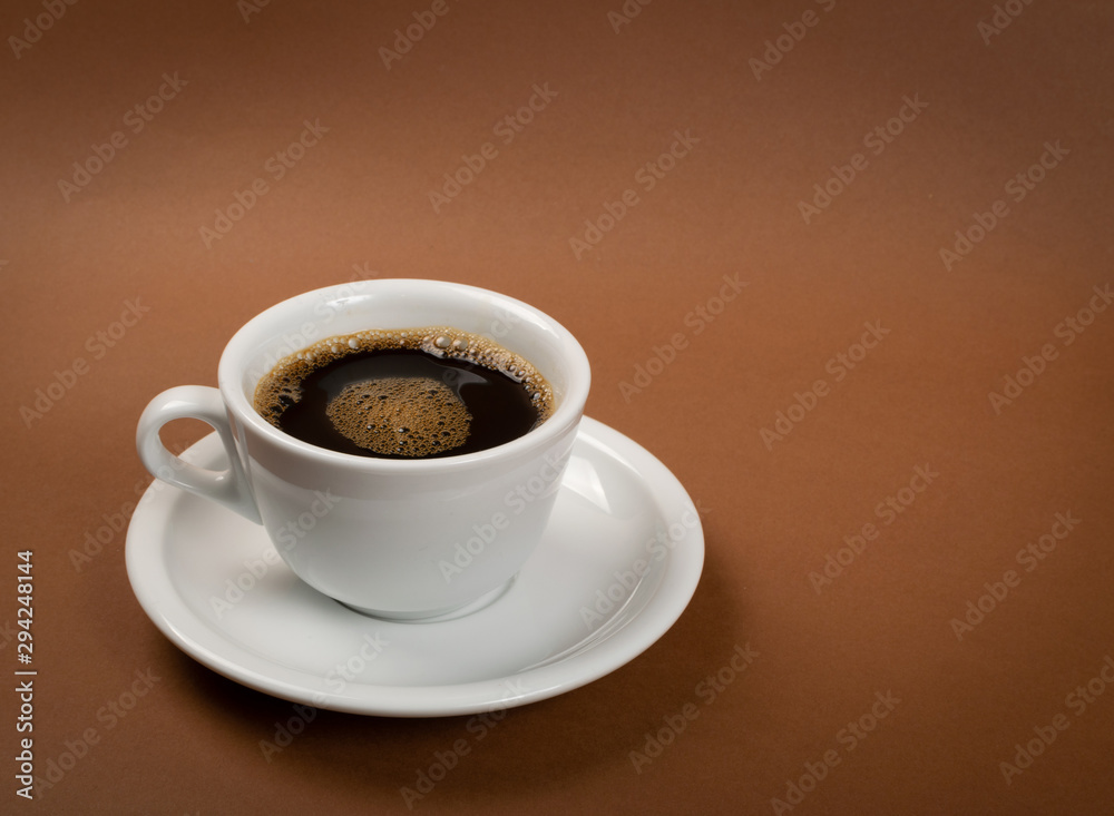 Hot coffee cup on brown background close up Hot coffee cup on brown background close up