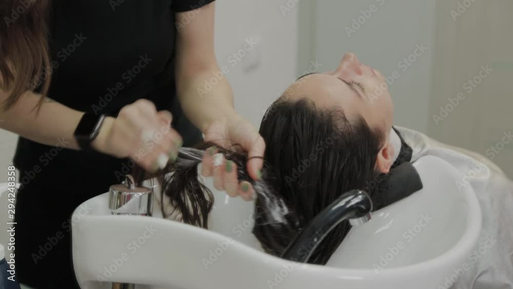 Beautiful young girl wash their hair at the hairdresser. Beautiful young girl wash their hair at the hairdresser.