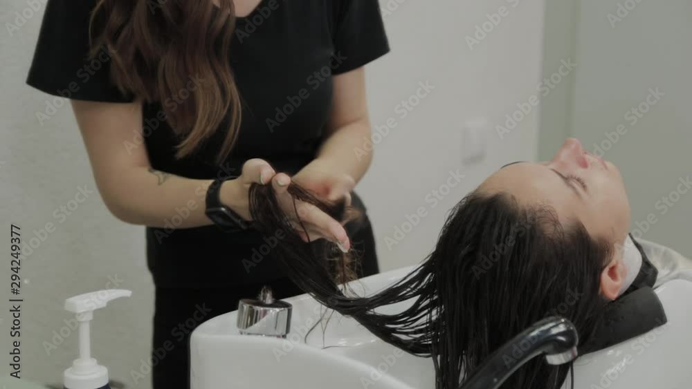 Beautiful young girl wash their hair at the hairdresser. Beautiful young girl wash their hair at the hairdresser.