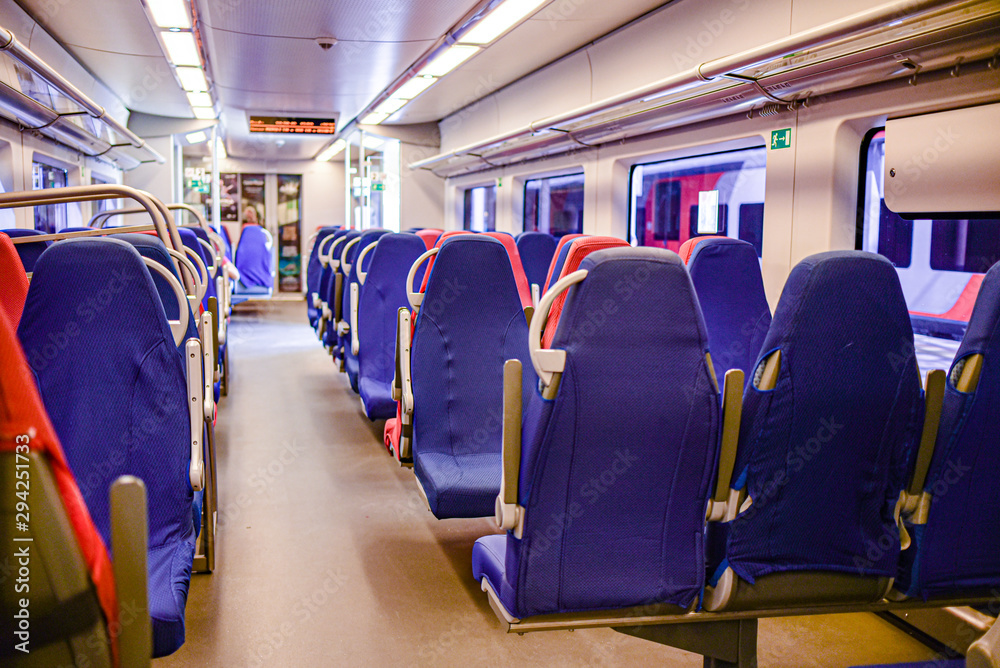 empty electric train blue and red chairs. no people empty electric train blue and red chairs. no people