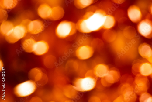 Yellow bokeh in motion on a red background © savelov
