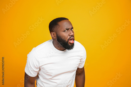 Shocked African-American man on color background photo