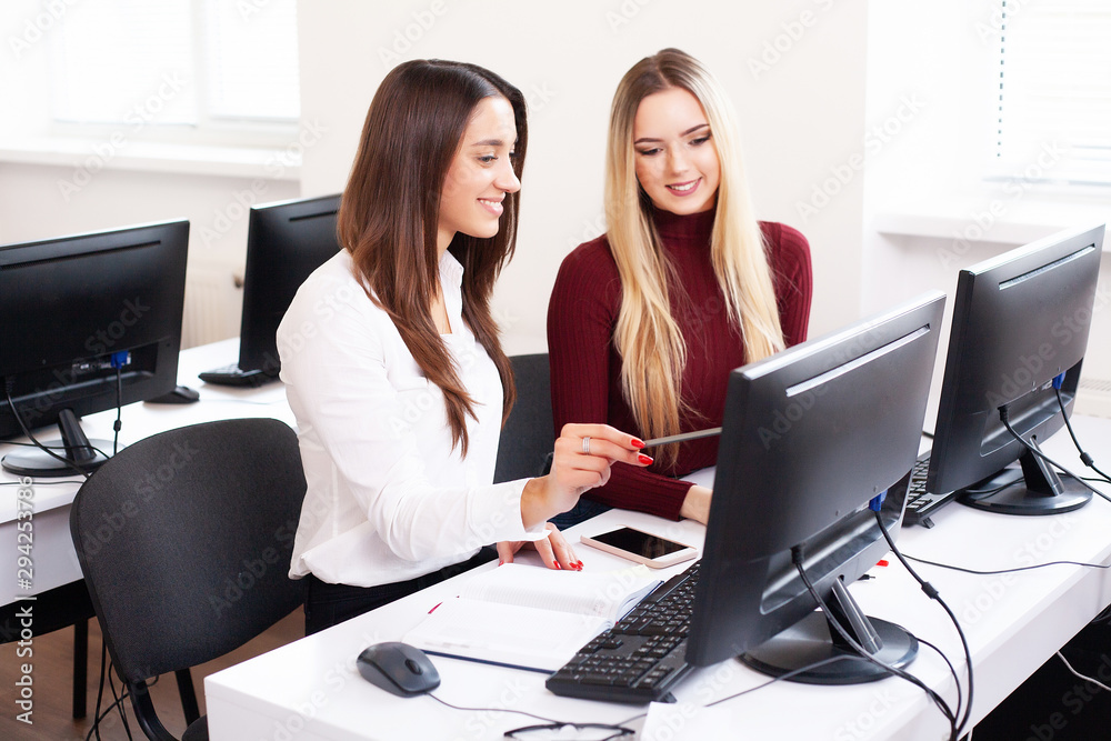Two beautiful girls work in the office of a consulting company Two beautiful girls work in the office of a consulting company