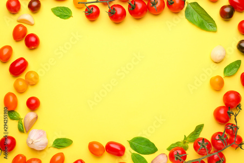 Frame made of fresh vegetables and basil on color background