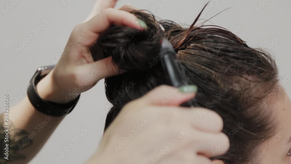 Girl hairdresser dries hair to client with hairdryer at hairdresser. Girl hairdresser dries hair to client with hairdryer at hairdresser.