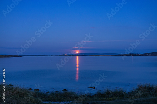 Red moon setting at early morning, Port arthur, Gweedore, County Donegal, Ireland