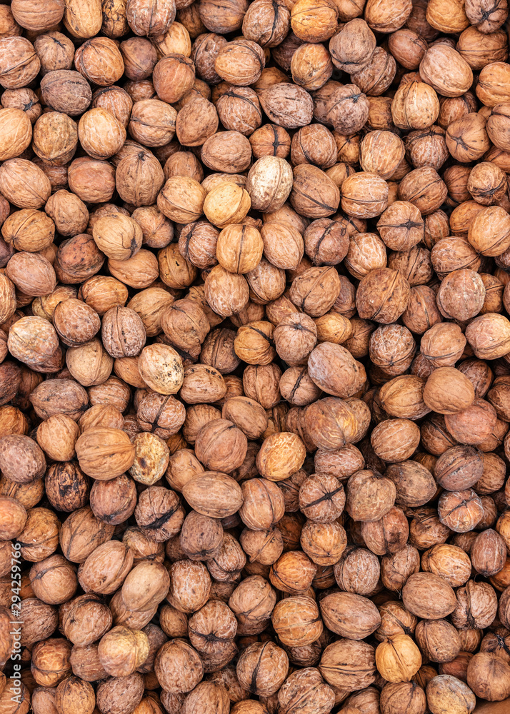 Heap of Walnuts for background texture, close-up, top view, copy space for text Heap of Walnuts for background texture, close-up, top view, copy space for text