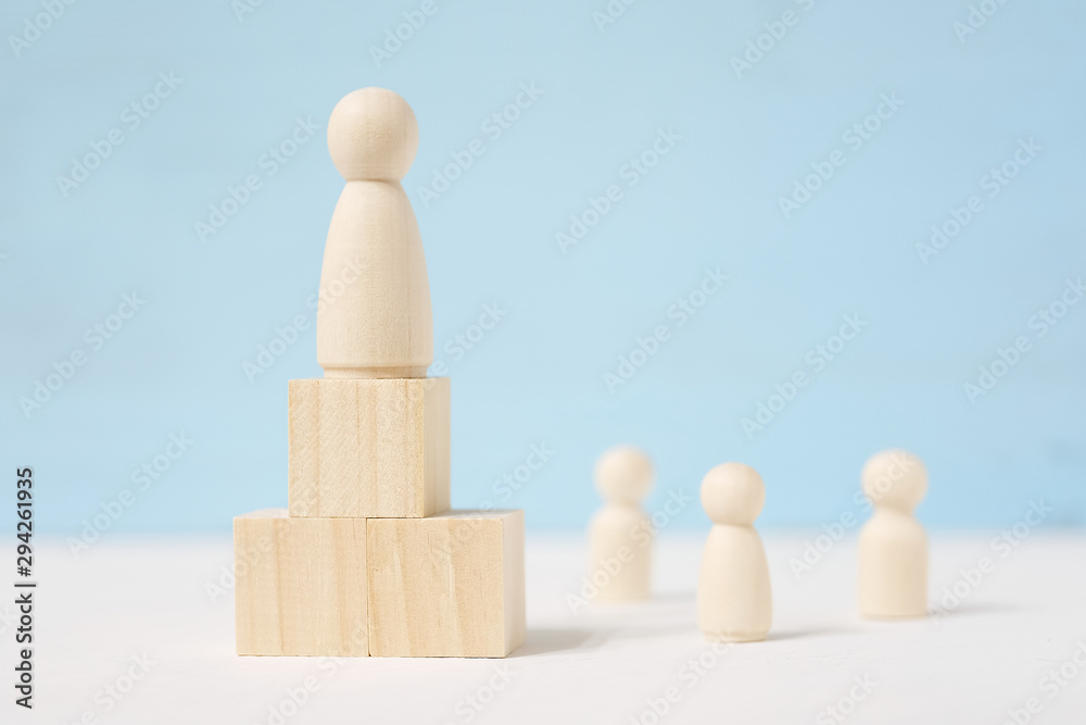 Figure of man on blocks are located as podium and people beside him. Figure of man on blocks are located as podium and people beside him.
