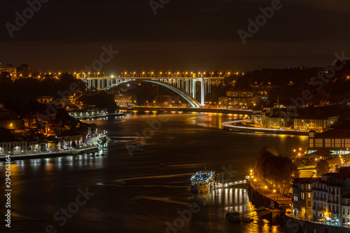 City of Porto at night  looking over Douro River with Arrabida Bridge at distance