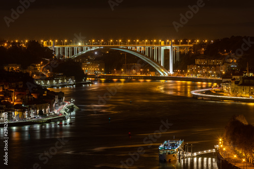City of Porto at night, looking over Douro River with Arrabida Bridge at distance © Angelino