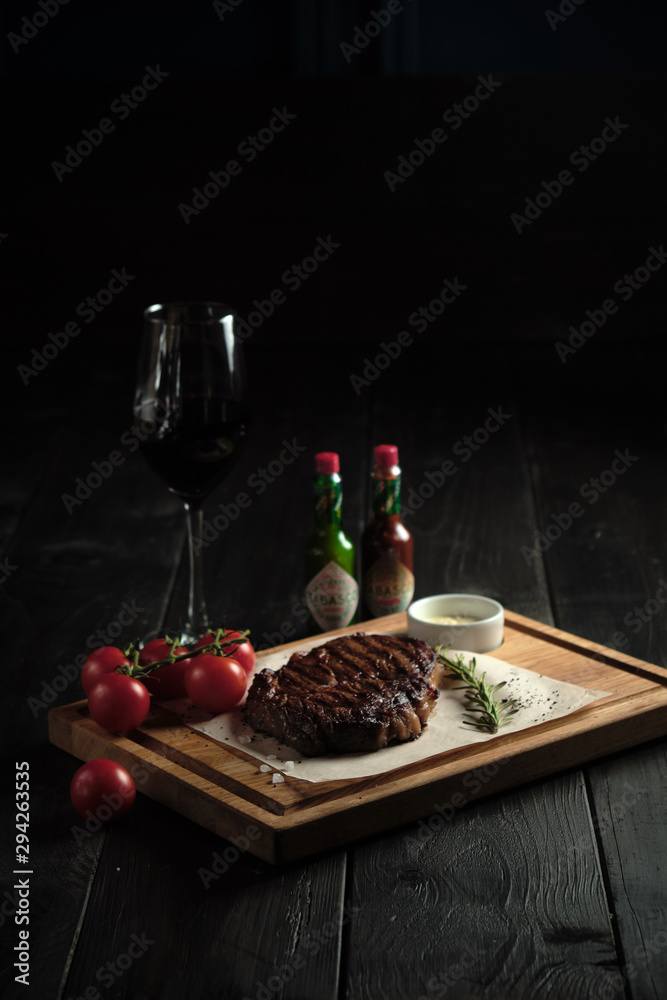 Meat steak on a wooden board. catering menu
