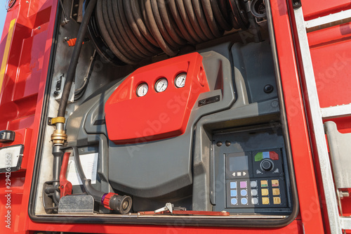 Modern control panel and extinguishing hose mounted on fire truck or fire engine, close-up