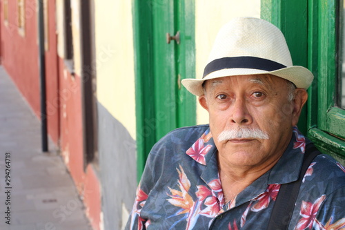 Senior Hispanic man looking at camera with incredulity 