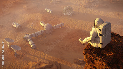 Fototapeta Naklejka Na Ścianę i Meble -  astronaut on planet Mars, sitting on a cliff above a research station