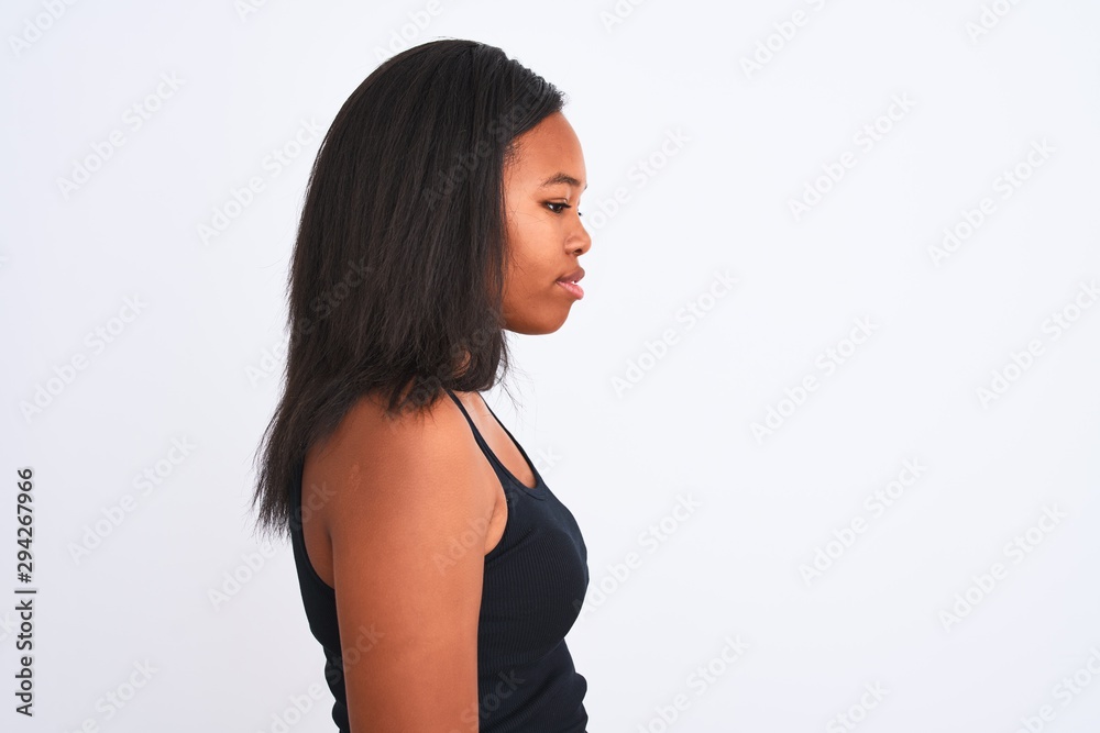 Beautiful young african american woman over isolated background looking to side, relax profile pose with natural face with confident smile. Beautiful young african american woman over isolated background looking to side, relax profile pose with natural face with confident smile.