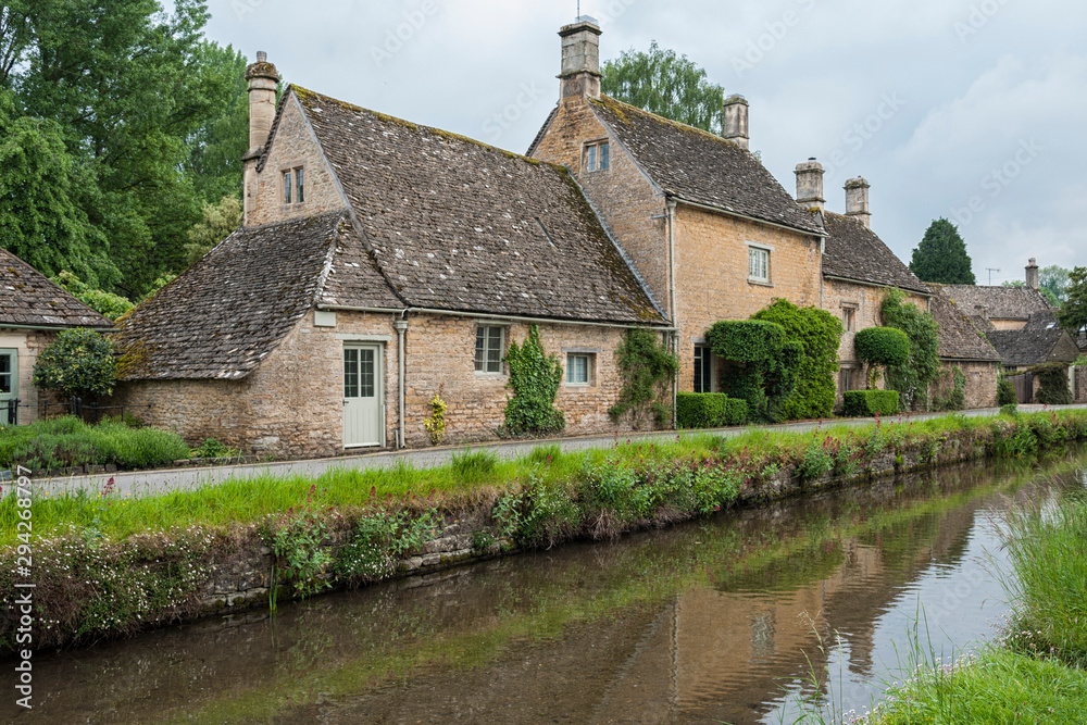 LOWER SLAUGHTER, COTSWOLDS, GLOUCESTERSHIRE, ENGLAND - MAY, 27 2018: Typical Cotswold cottages on the River Eye, Lower Slaughter, Gloucestershire, Cotswolds, England, UK LOWER SLAUGHTER, COTSWOLDS, GLOUCESTERSHIRE, ENGLAND - MAY, 27 2018: Typical Cotswold cottages on the River Eye, Lower Slaughter, Gloucestershire, Cotswolds, England, UK
