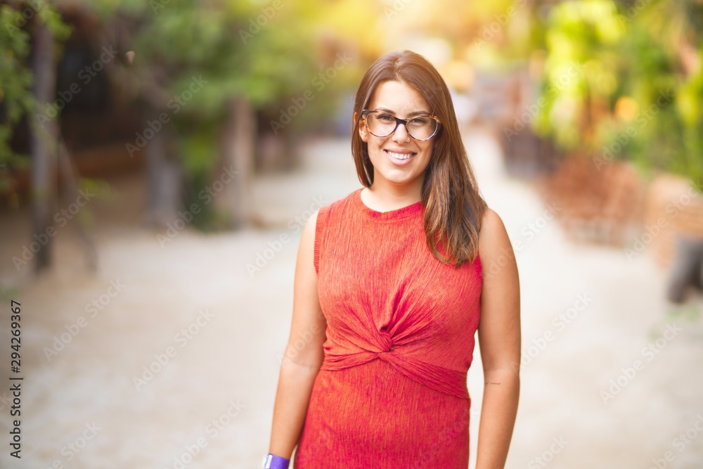 Young beautiful girl smiling happy and confident walking at the town park, standing with a smile on face Young beautiful girl smiling happy and confident walking at the town park, standing with a smile on face