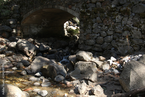 Old stone bridge across a small mountain stream