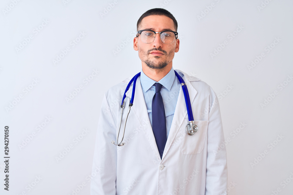 Young doctor man wearing stethoscope over isolated background skeptic and nervous, frowning upset because of problem. Negative person. Young doctor man wearing stethoscope over isolated background skeptic and nervous, frowning upset because of problem. Negative person.