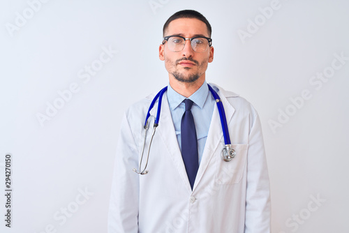 Young doctor man wearing stethoscope over isolated background skeptic and nervous, frowning upset because of problem. Negative person.
