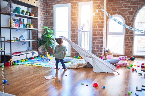 Young beautiful toddler playing at kindergaten photo