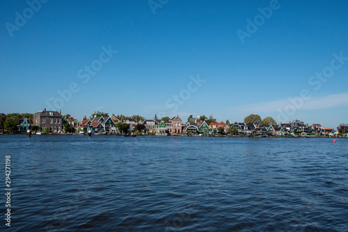 Zaanse Schans, Netherlands - 1 October 2019: Tourists sightseeng traditional Dutch rural houses in Zaanse Schans, is a typical small village within Amsterdam area. photo