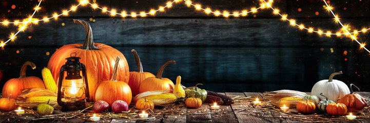 Wooden Table With Lantern And Candles Decorated With Pumpkins, Corncobs, Apples And Gourds - Thanksgiving / Harvest Concept