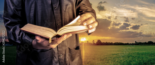 Photography Koran in hand - holy book of Muslims ( public item of all muslims )