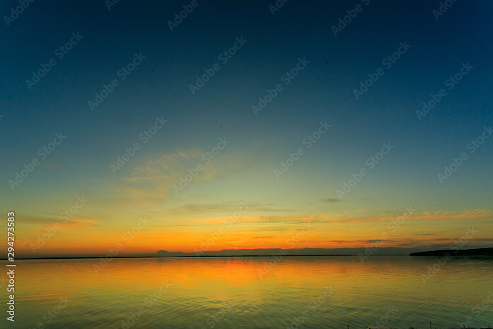 Bright orange sky and light of the sun. Sky background on sunset. Nature composition. Panoramic sunset sky background