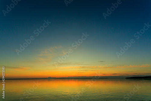 Bright orange sky and light of the sun. Sky background on sunset. Nature composition. Panoramic sunset sky background