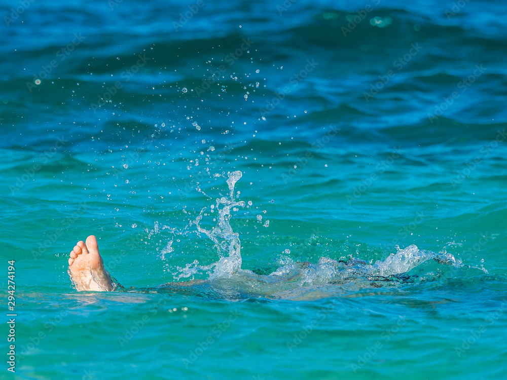 Heel of kid swimming in the tropical sea