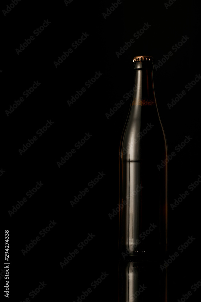 dark glass bottle of beer isolated on black dark glass bottle of beer isolated on black