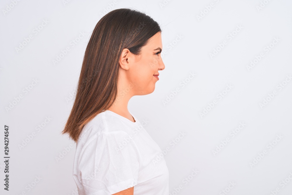 Portrait of beautiful and young brunette woman standing over isolated white background looking to side, relax profile pose with natural face with confident smile. Portrait of beautiful and young brunette woman standing over isolated white background looking to side, relax profile pose with natural face with confident smile.