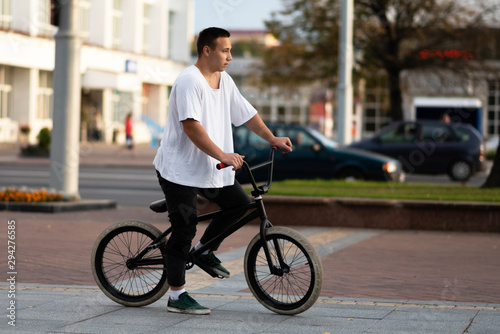 Young guy on a BMX bike, look forward.