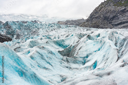 Tourists visit the Nigardsbreen Glacier, an arm of the Jostedalsbreen glacier, Jostedalsbreen National Park. © rayints