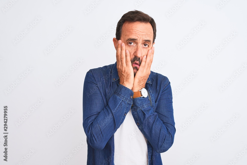 Middle age handsome man wearing blue denim shirt standing over isolated white background Tired hands covering face, depression and sadness, upset and irritated for problem Middle age handsome man wearing blue denim shirt standing over isolated white background Tired hands covering face, depression and sadness, upset and irritated for problem