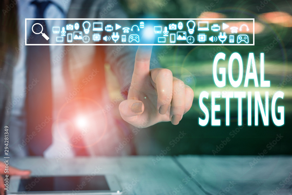 Writing note showing Goal Setting. Business concept for process of identifying something that you want to accomplish Woman wear formal work suit presenting presentation using smart device Writing note showing Goal Setting. Business concept for process of identifying something that you want to accomplish Woman wear formal work suit presenting presentation using smart device