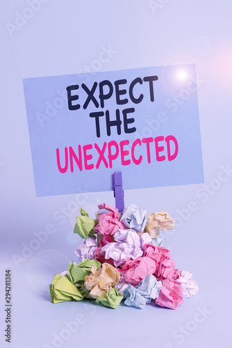 Text sign showing Expect The Unexpected. Business photo text Anything can Happen Consider all Possible Events Reminder pile colored crumpled paper clothespin reminder blue background