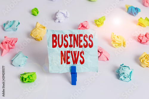 Handwriting text Business News. Conceptual photo Commercial Notice Trade Report Market Update Corporate Insight Colored crumpled papers empty reminder white floor background clothespin