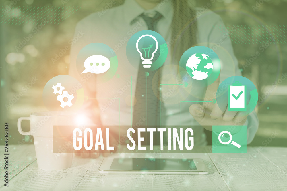 Fototapeta premium Handwriting text writing Goal Setting. Conceptual photo process of identifying something that you want to accomplish Female human wear formal work suit presenting presentation use smart device