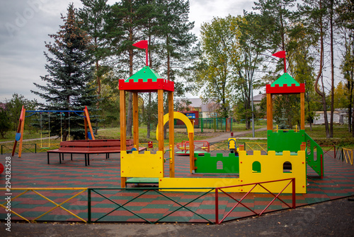 playground in the park swings, slides of a building of different colors for children's games
