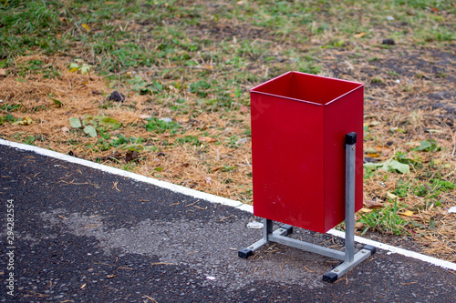 red iron litter box along the road