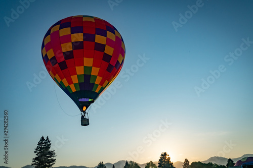 Colorful hot air balloon over Grants Pass Oregon on a beautiful summer morning