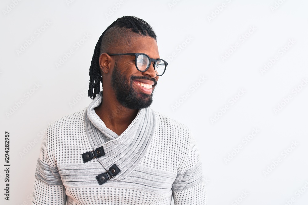 African american man wearing grey sweater and glasses over isolated white background looking away to side with smile on face, natural expression. Laughing confident. African american man wearing grey sweater and glasses over isolated white background looking away to side with smile on face, natural expression. Laughing confident.