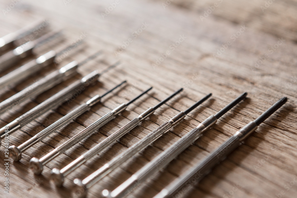 Selective focus of Many sizes screwdriver on the wood background with sunlight Selective focus of Many sizes screwdriver on the wood background with sunlight