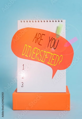 Writing note showing Are You Diversified Question. Business concept for someone who is Different Mixed Multi Faceted Spiral notepad box speech bubble arrow banners cool colored background photo