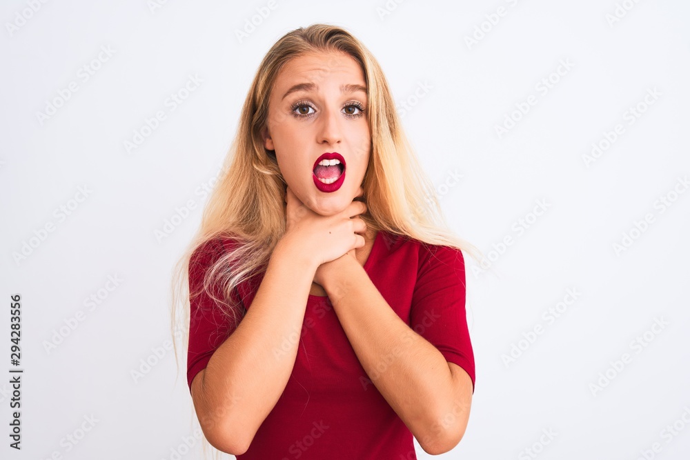 Young beautiful woman wearing red t-shirt standing over isolated white background shouting and suffocate because painful strangle. Health problem. Asphyxiate and suicide concept. Young beautiful woman wearing red t-shirt standing over isolated white background shouting and suffocate because painful strangle. Health problem. Asphyxiate and suicide concept.
