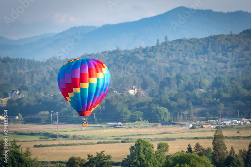 Colorful hot air balloon over Grants Pass Oregon on a beautiful summer morning