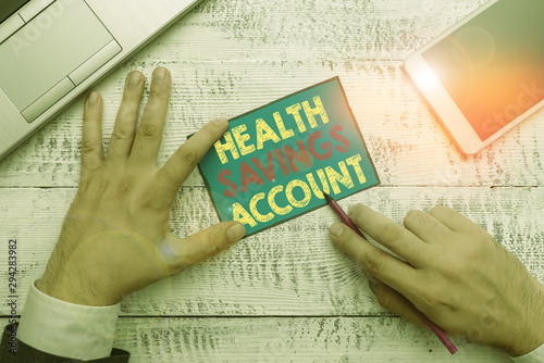 Writing note showing Health Savings Account. Business concept for users with High Deductible Health Insurance Policy photo